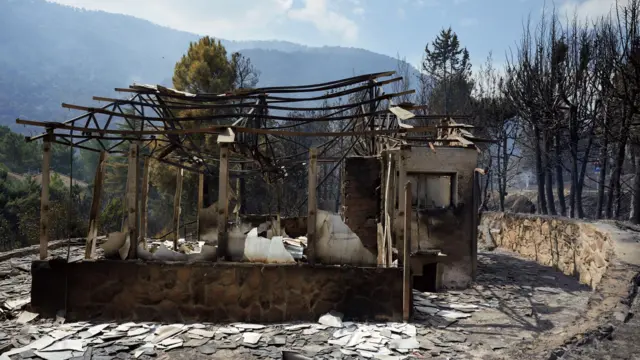 Damage to a house in the village of Burgohonfo, Avila province, as wildfires continue to rage in central Spain