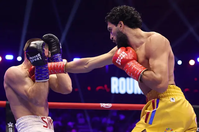 Hamzah Sheeraz punches Simon Zachenhuber
