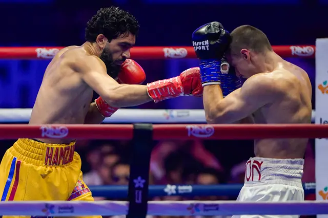 Hamzah Sheeraz punching Simon Zachenhuber