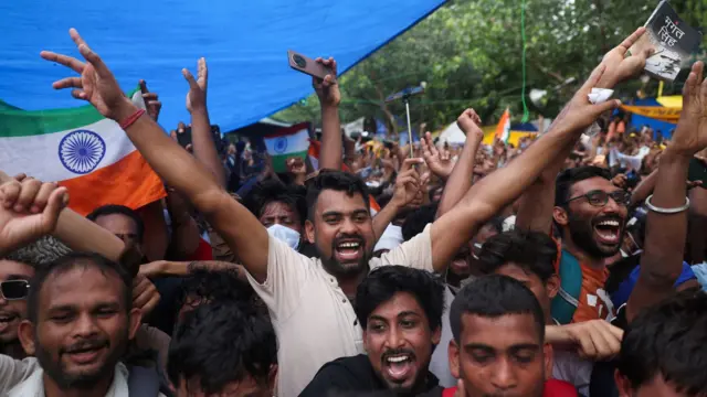 Cockroach Janta Party (CJP) supporters celebrate after the resignation of Education Minister Dharmendra Pradhan over National Eligibility cum Entrance Test (NEET) examination paper leaks,