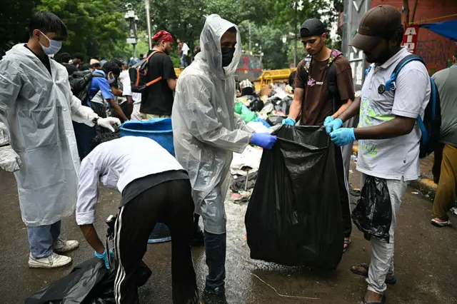 INDIA-POLITICS-EDUCATION-PROTEST Cockroach Janta Party (CJP) supporters clear trash at Jantar Mantar in New Delhi on July 22, 2026 during the ongoing protest to demand the resignation of India's Education Minister Dharmendra Pradhan over alleged NEET exam irregularities. (Photo by Sajjad HUSSAIN / AFP via Getty Images)
