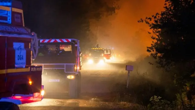 A handout photo made available by the French Landes Prefecture shows firefighters at the scene of a forest fire in Biscarrosse, southern France, 25 July 2026.