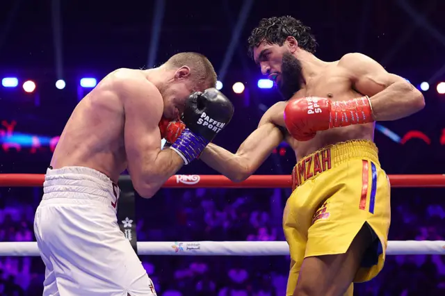 Hamzah Sheeraz punching Simon Zachenhuber