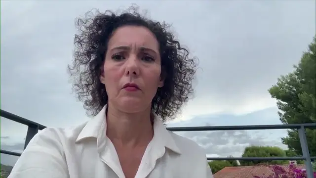 Hadja Lahbib, EU Commissioner for Crisis Management speaks to BBC Breakfast wearing white shirt with outdoor scene behind her