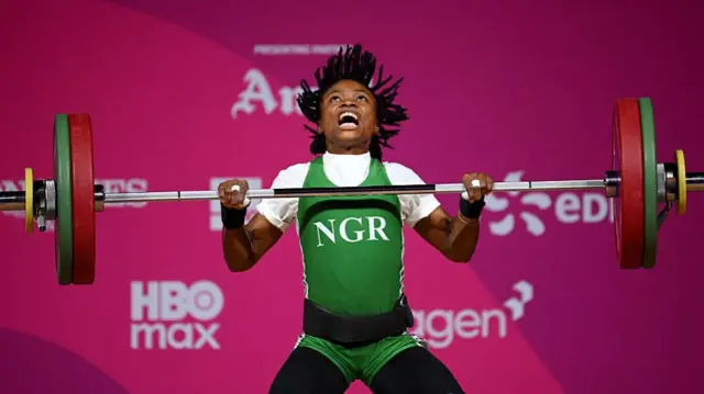 Ruth Asuquo Nyong of Team Nigeria competes during the Women's 48kg Weightlifting on day three