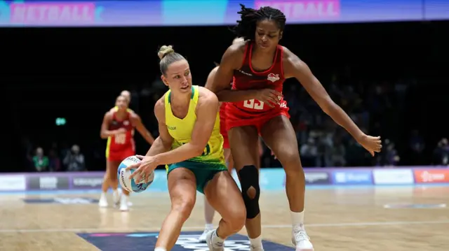 Jamie-Lee Price of Team Australia competes for the ball with Olivia Tchine of Team England during the Netball Preliminary Pool A match between Team Australia and Team England