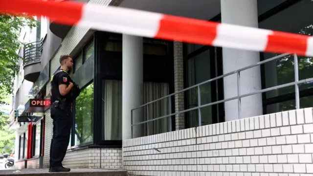 A policeman looks on as police search an apartment on Bissingzeile street in the Tiergarten neighbourhood