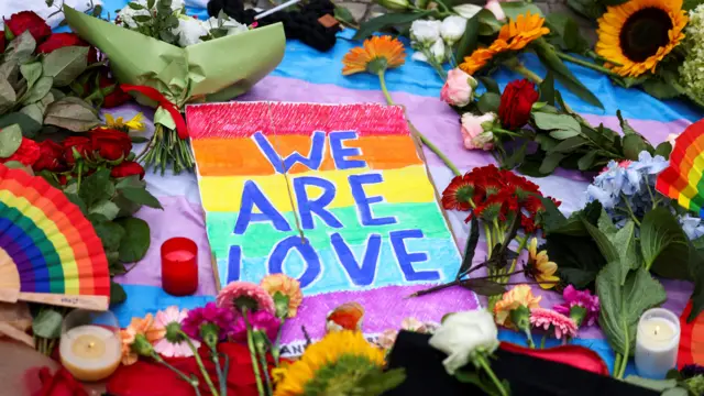 Flowers, mementos and candles left by people at the Brandenburg Gate,