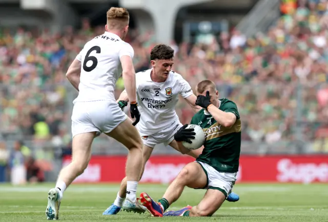 Kerry's Dylan Casey is tackled by Mayo's Jack Coyne