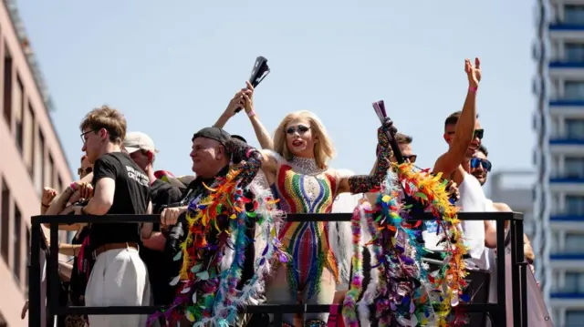 Participants travel on a float during the annual Christopher Street Day Pride parade