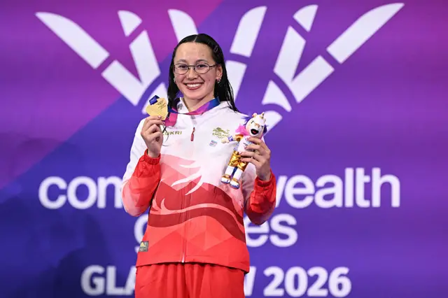 England's Alice Tai celebrates with their gold medal during the Women's 100m Backstroke S9