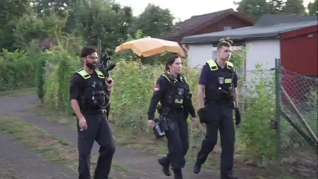 POlice walking with large guns