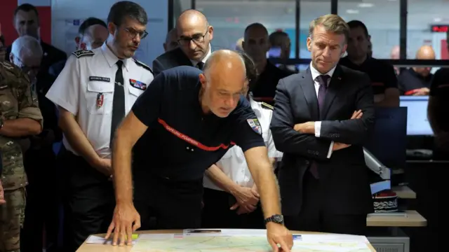 Emmanuel Macron and France's Interior Minister Laurent Nunez attend a situation briefing in the crisis room at the Departmental Fire and Rescue Operational Center (CODIS) in Bordeaux,