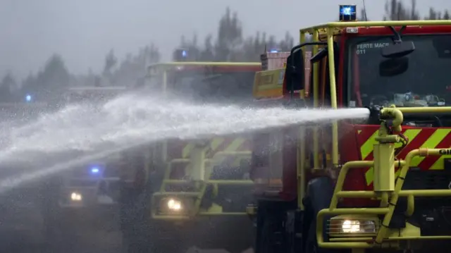 Fire engines carry out edge protection and mop-up operations on a wildfire in Marcheprime, in the Gironde region, amid worsening drought conditions following a heatwave and water shortages across much of France, July 27, 2026.