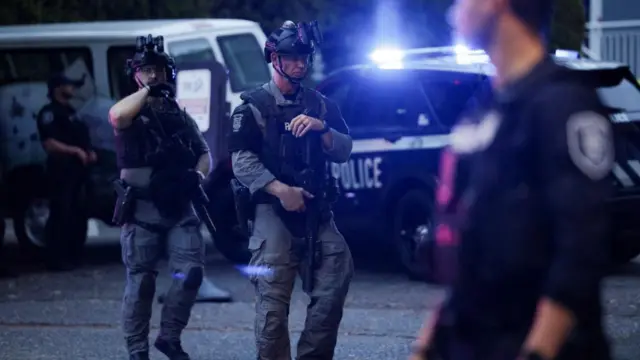 Police officers guard an area after Seattle Police responded to what they described as a shooting with "multiple" victims at Seattle Center,