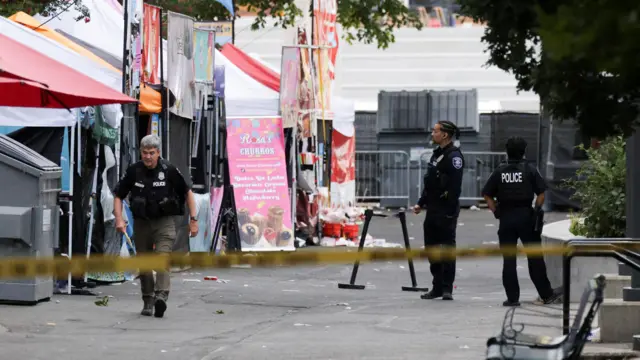 Police officers stand guard at the Seattle Center, which was hosting a Bite of Seattle food festival