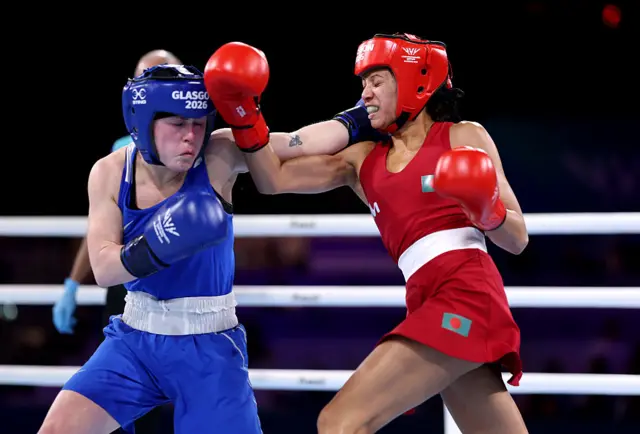 Zinnat Ferdous of Team Bangladesh punches Caitlin Fryers of Team Northern Ireland