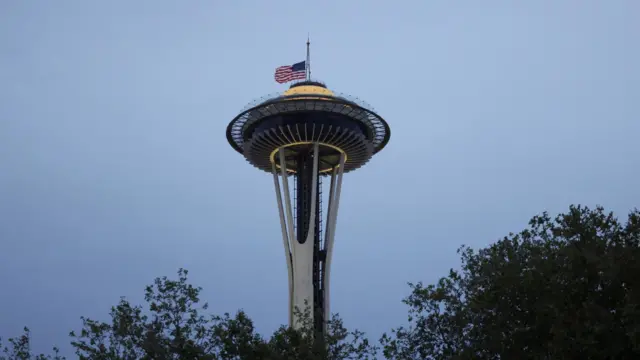 A US flag flies at half-mast on the Space Needle after Seattle Police responded to the shooting