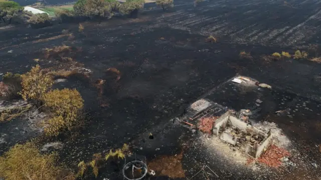 A destroyed building can be seen next to scorched earth in the south west of France