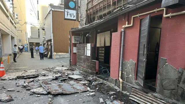 A shop with a collapsed front damaged in an earthquake