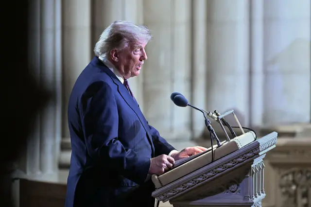 Profile of Trump at lectern with two microphones