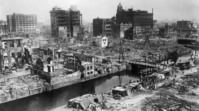 Flattened buildings and rubble pictured in a black and white photograph of Tokyo