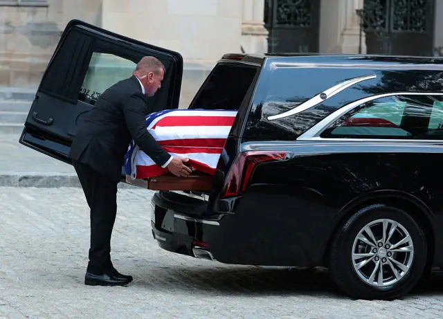 Lindsey Graham's coffin is carried into the funeral