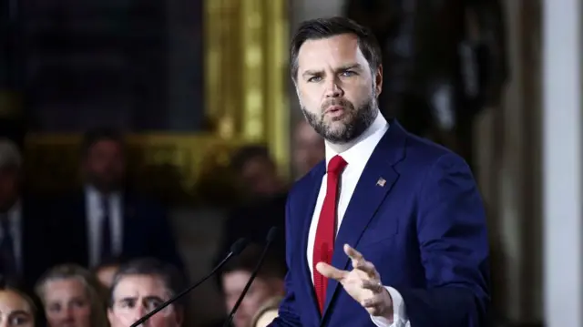 US Vice-President JD Vance wears a navy suit and red tie as he delivers remarks during a tribute for late South Carolina Senator Lindsey Graham