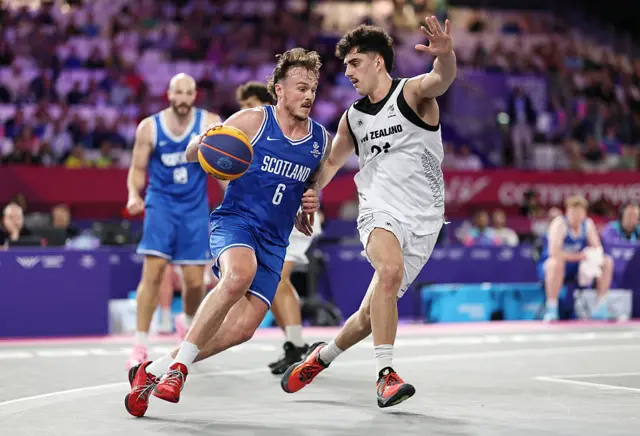 Kyle Jimenez of Team Scotland is challenged by Christian Martin of Team New Zealand