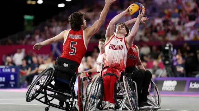England's Thomas Harvey is challenged by Garrett Ostepchuk of Team Canada during the 3x3 wheelchair basketball men's semi-final