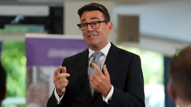 Andy Burnham doing a speech and gesticulating with his hands
