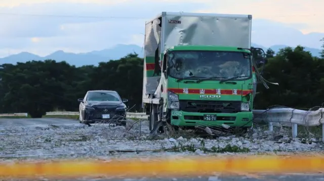 Damaged vehicles after the explosion at the Aeon Mall