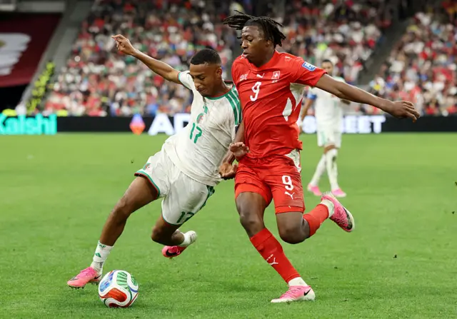 Rafik Belghali competes for the ball against Johan Manzambi
