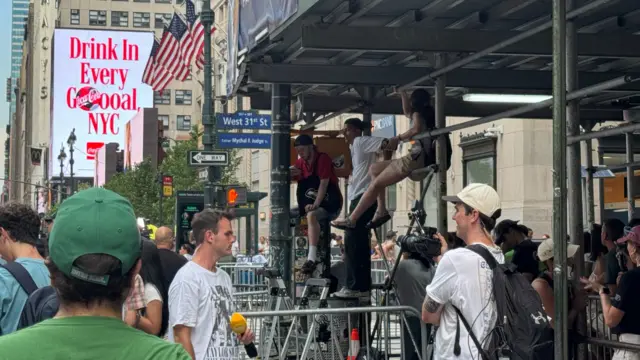 Taylor Swift's fans climb city scaffolding to get a glimpse of festivities around Madison Square Garden
