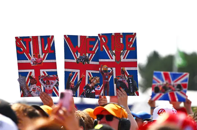 Fans hold up signs for Lewis Hamilton