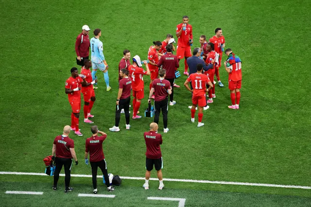 Switzerland players cool off during a hydration break
