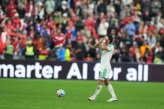 Players of Algeria react after conceding a goal