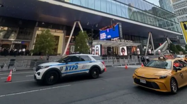 A police cab and a taxi are seen outside Penn Station
