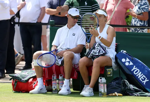Katie Swan of Great Britain and John Peers of Australia interact