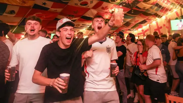 England supporters cheer after their team's first goal as they watch the football match between England and Panama at The Clock pub in Hebburn, north-east England