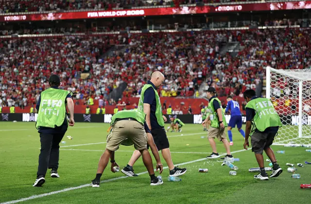Pitch staff clear bottles and cans thrown by fans