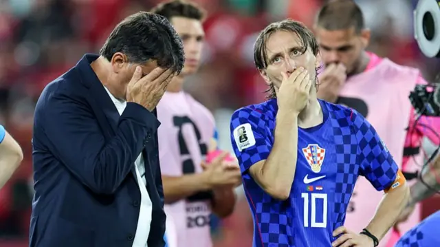 Luka Modric and coach Zlatko Dalic look devastated after Croatia's defeat