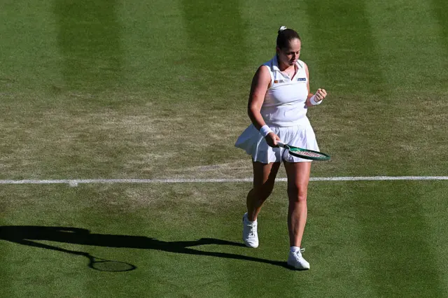 Jelena Ostapenko pumps her fist after winning point