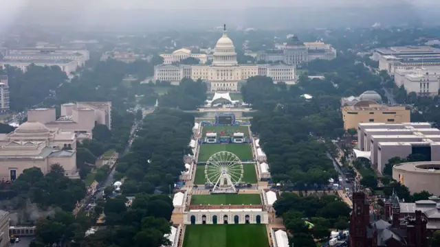 Wide shot of the Capitol building and National Mall showing tents of the Great American State Fair, a white ferris wheel in the centre