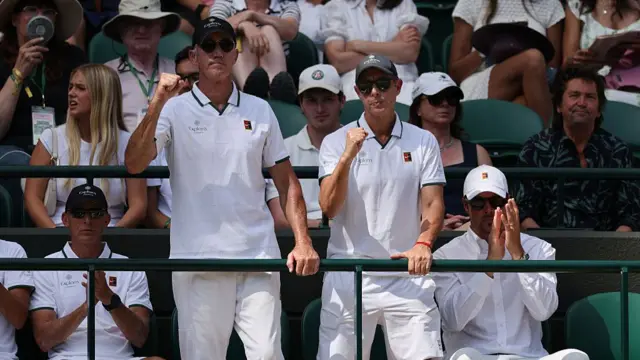 Jannik Sinner's Australian tennis coach Darren Cahill (2L) reacts