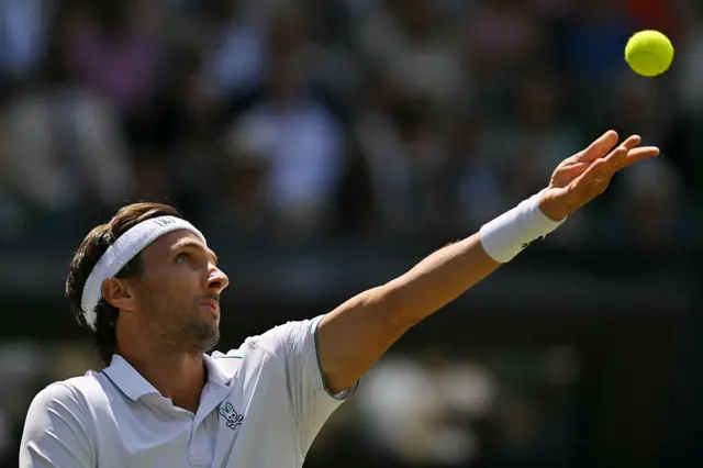 Arthur Rinderknech serves