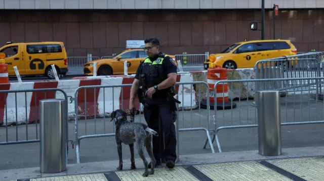 A member of the NYPD with a dog secures an area near Madison Square Garden