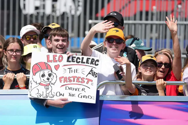 Fans hold up signs for Leo Leclerc