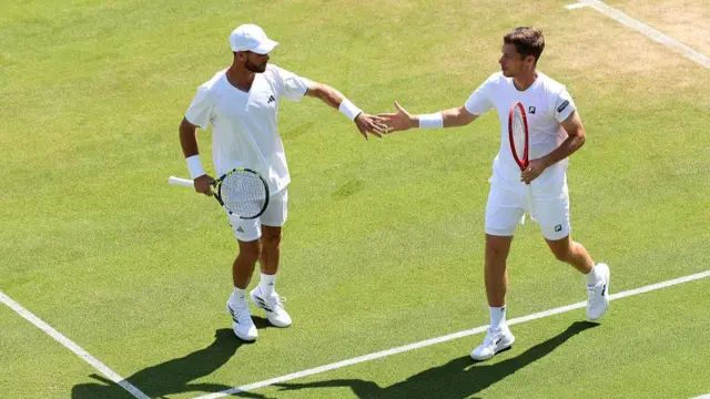 Christian Harrison of United States and Neal Skupski of Great Britain interact