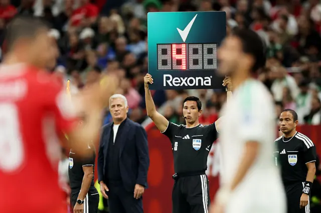 The fourth official holds up the substitution board